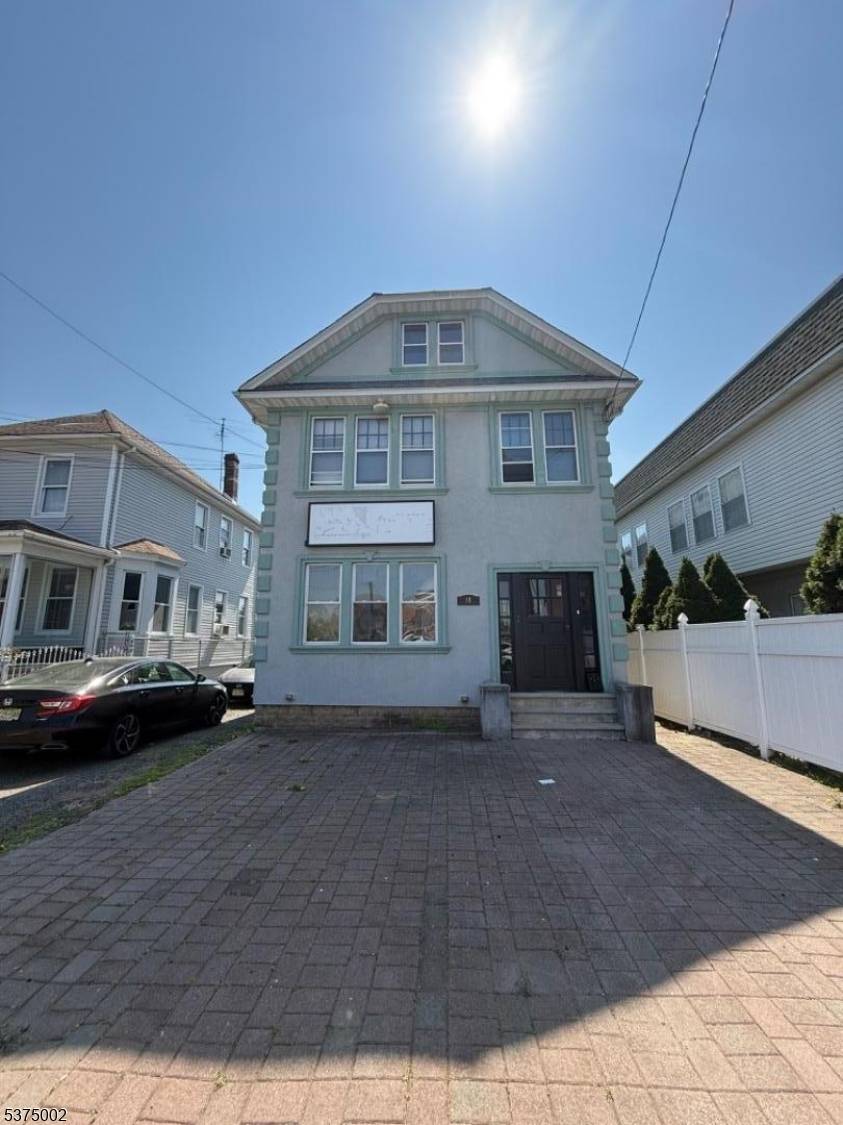 Mixed use commercial space featuring a 3 bedroom apartment on the second floor and a 4 car garage.