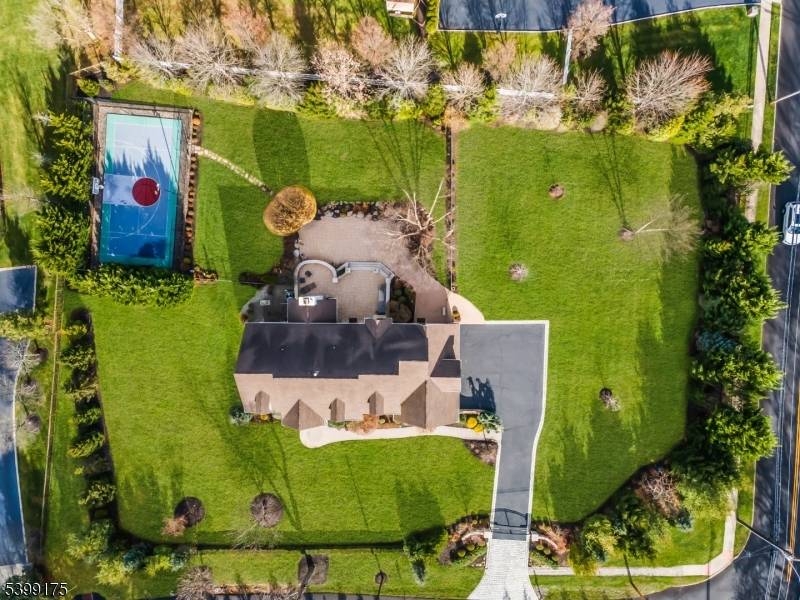 Impeccably manicured landscaping surrounds this private, gated front entry corner lot estate, offering a rare sense of tranquility and refinement.