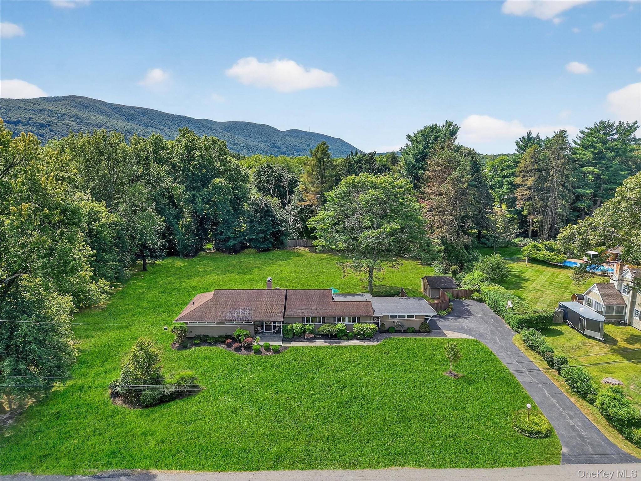 Set on one of the most coveted lots in the area, this well kept mid century ranch sits on 1.