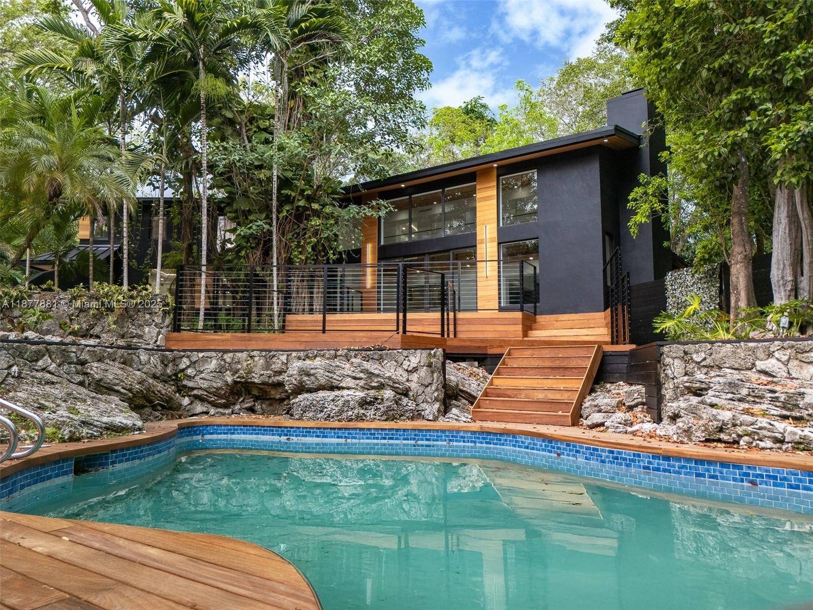 Experience timeless elegance in this Mid Century Modern residence set within the prestigious Devonwood community of Pinecrest.