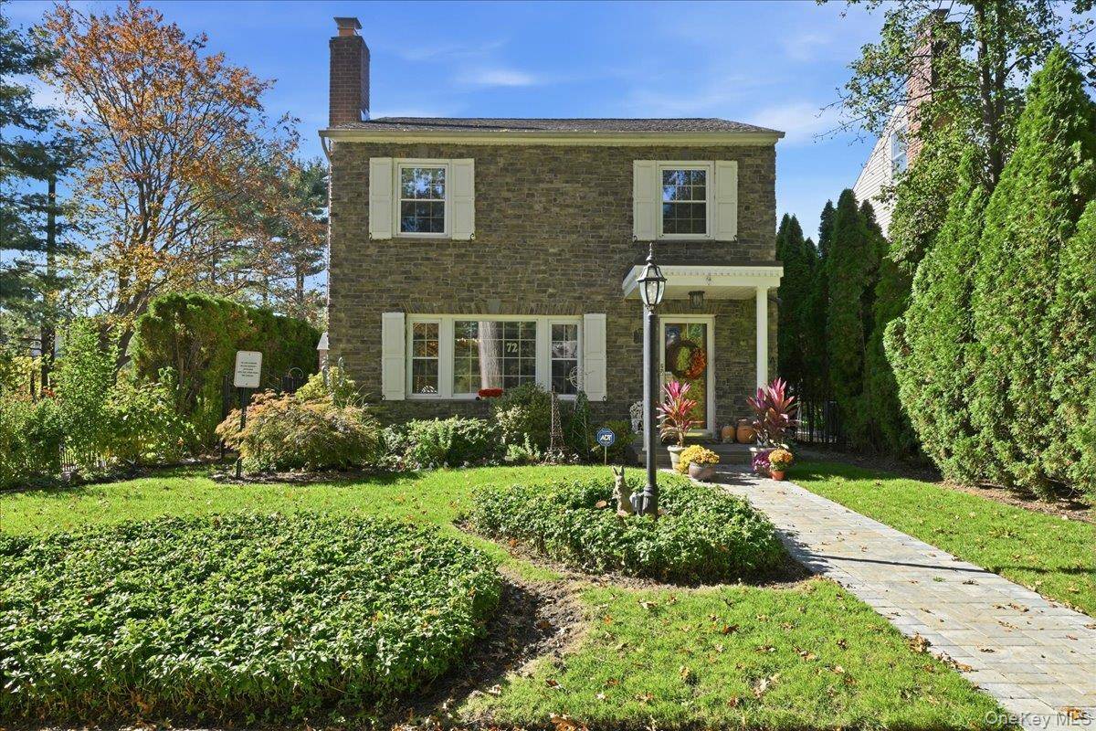 Delight in the charm of this sunlit stone colonial home located on a tree lined street in the Western Section of Garden City Village.