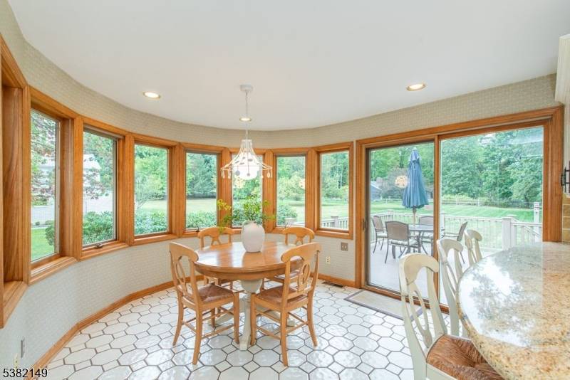 Custom Brick Split level on over 1 2 acre lot with Cathedral ceiling, Hardwood floors, Balcony, Custom Built ins, Pergola Breakfast Room with sliders to one of two Trex decks.