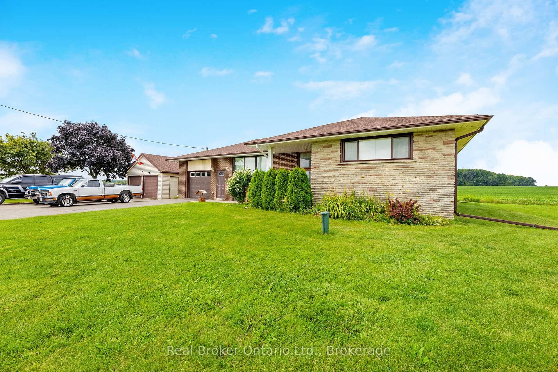 Spacious raised bungalow with a wide driveway and detached garage, offering plenty of parking.