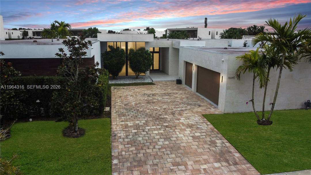 Welcome to this stunning modern lakefront residence located in the prestigious gated community of Botaniko Estates in Weston.