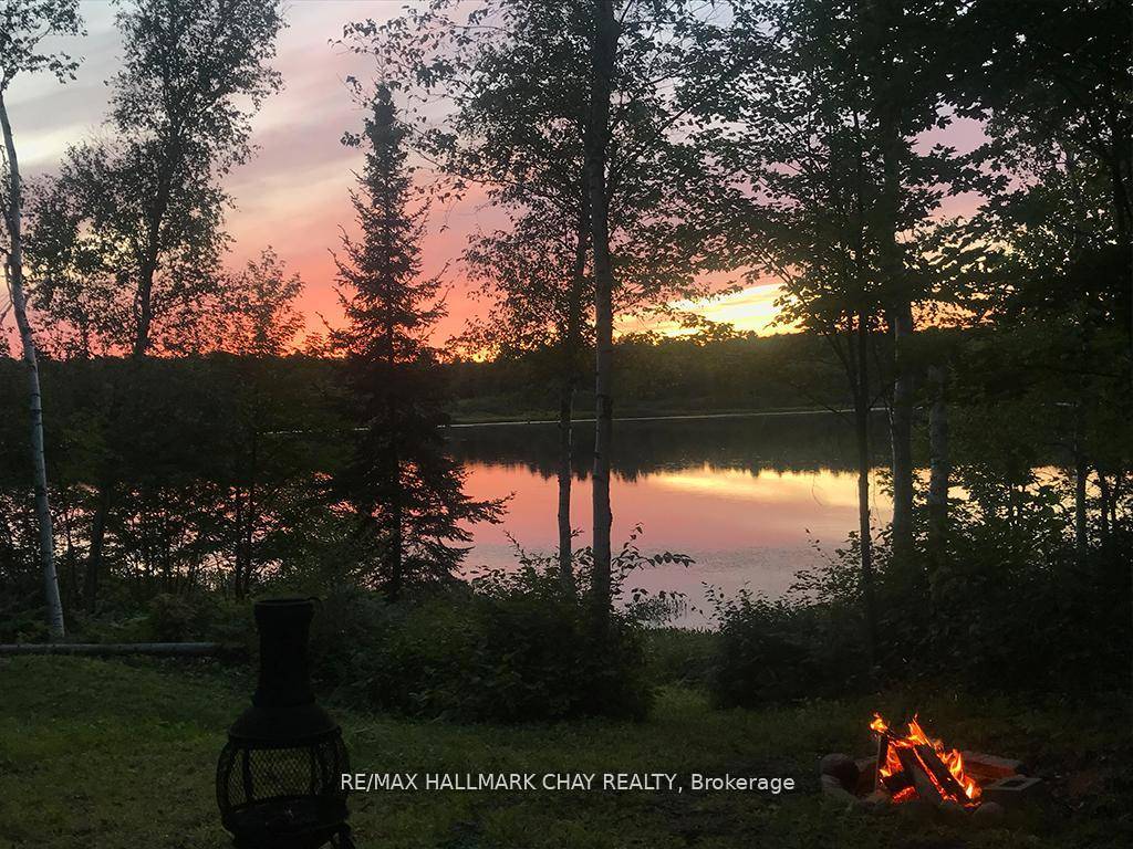 Welcome to your private nature retreat on Barkway Lake, featuring 125 feet of west facing lakefront.