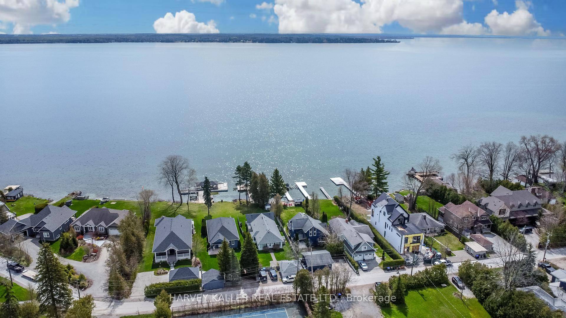 Boasting a rare sandy shoreline, a private dock, this waterfront home invites you to indulge in the tranquil beauty of lakeside living.