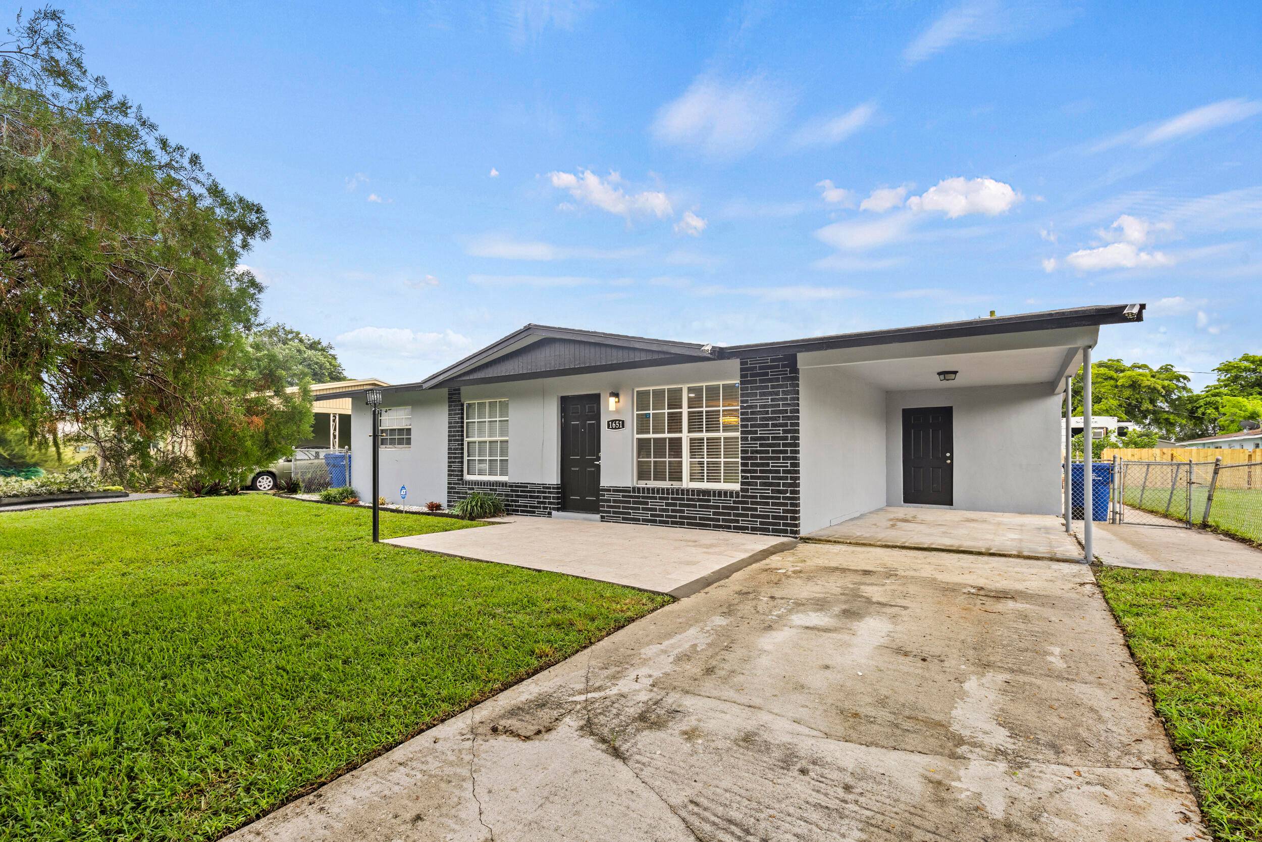 Beautifully remodeled 3 bedroom plus den office, 2 bathroom CBS home with a carport in the heart of Riviera Beach !