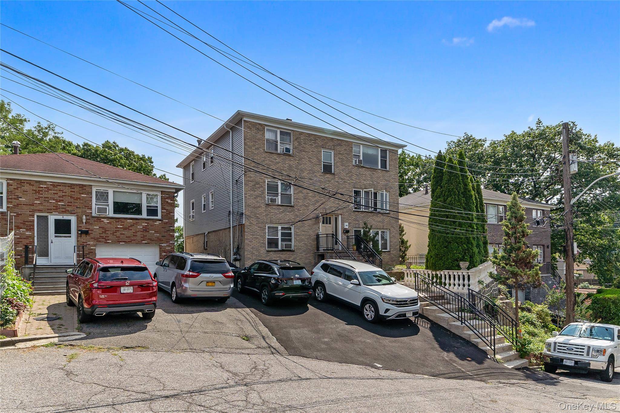 Welcome to 8 Elicar Terrace, a stunning brick Colonial duplex nestled on a quiet, tree lined street in Yonkers' sought after Bryn Mawr neighborhood.
