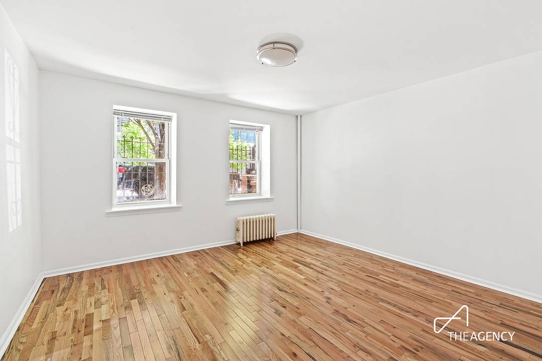A PRIVATE PATIO overlooks a lush garden in this renovated and sprawling one bedroom home.