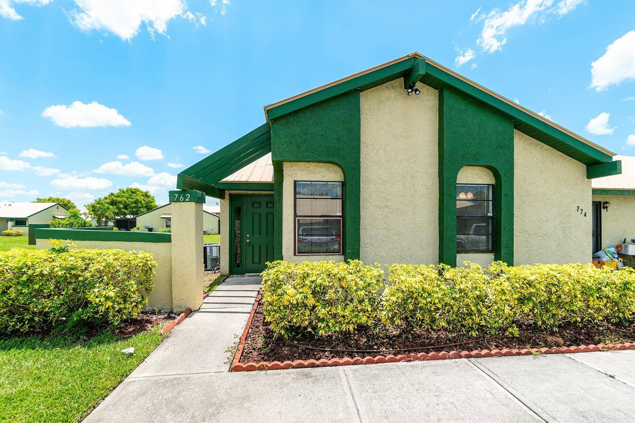 Beautifully renovated 3 bedroom, 2 bath villa end unit featuring a stunning new kitchen with white cabinets, granite countertops, and stainless steel appliances.