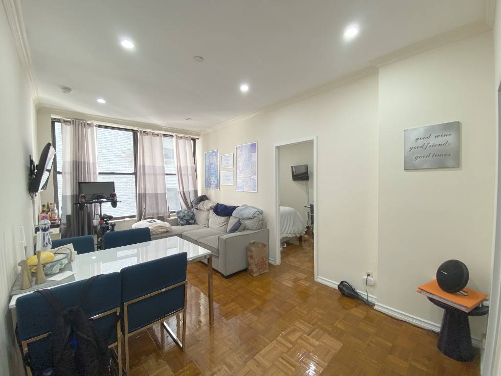A spacious split layout two bedroom apartment with central air in a luxury doorman building with a roof deck and laundry room.