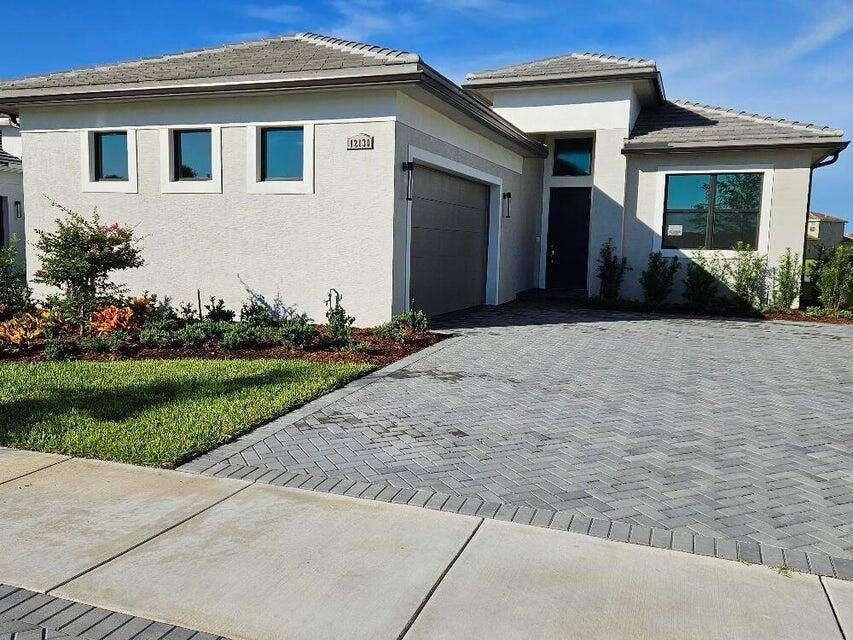LILA model with extended Master Bedroom and Lanai and 16 feet sliding glass door on a premium wide lake lot.