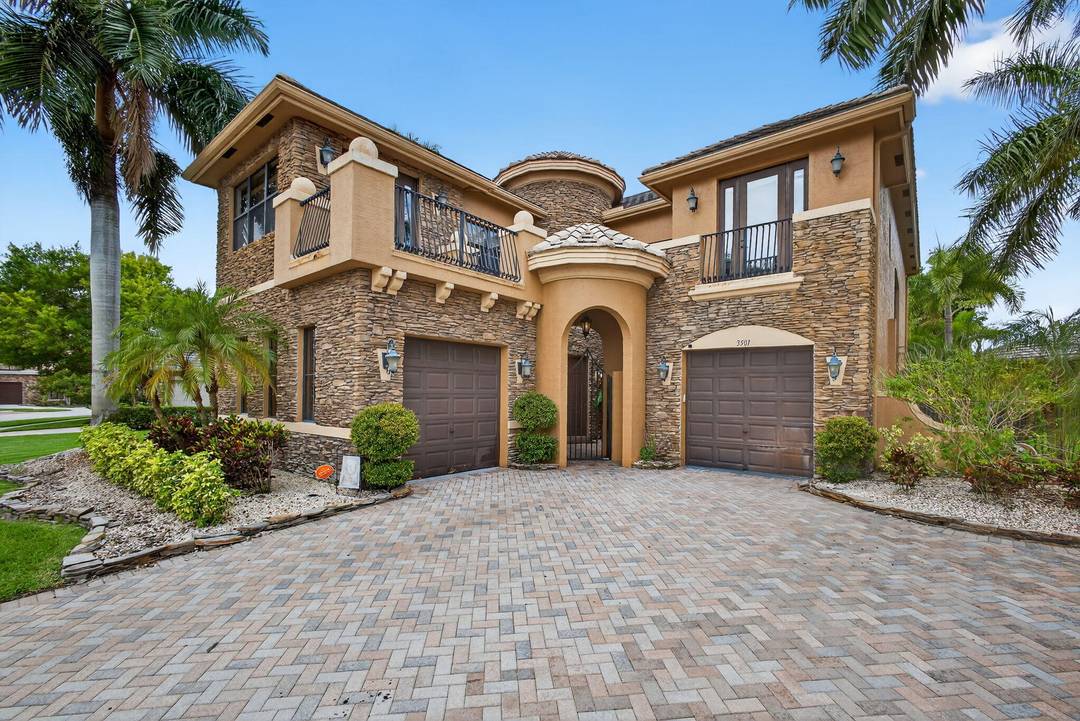 Experience luxury lakefront living in this highly desirable Moulin Rouge model, located within the prestigious, guard gated Versailles community in the heart of Wellington.