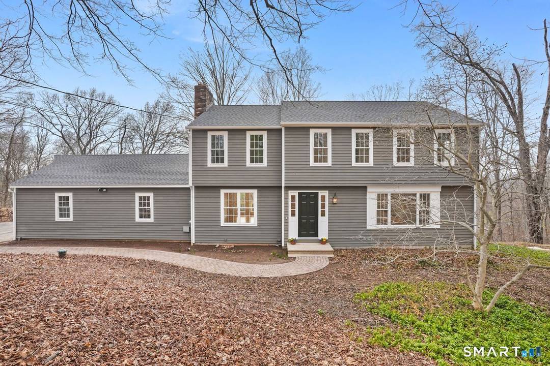 Tucked away on a picturesque, tree lined road in the desirable Mount Carmel section of Hamden, this exceptional 1.