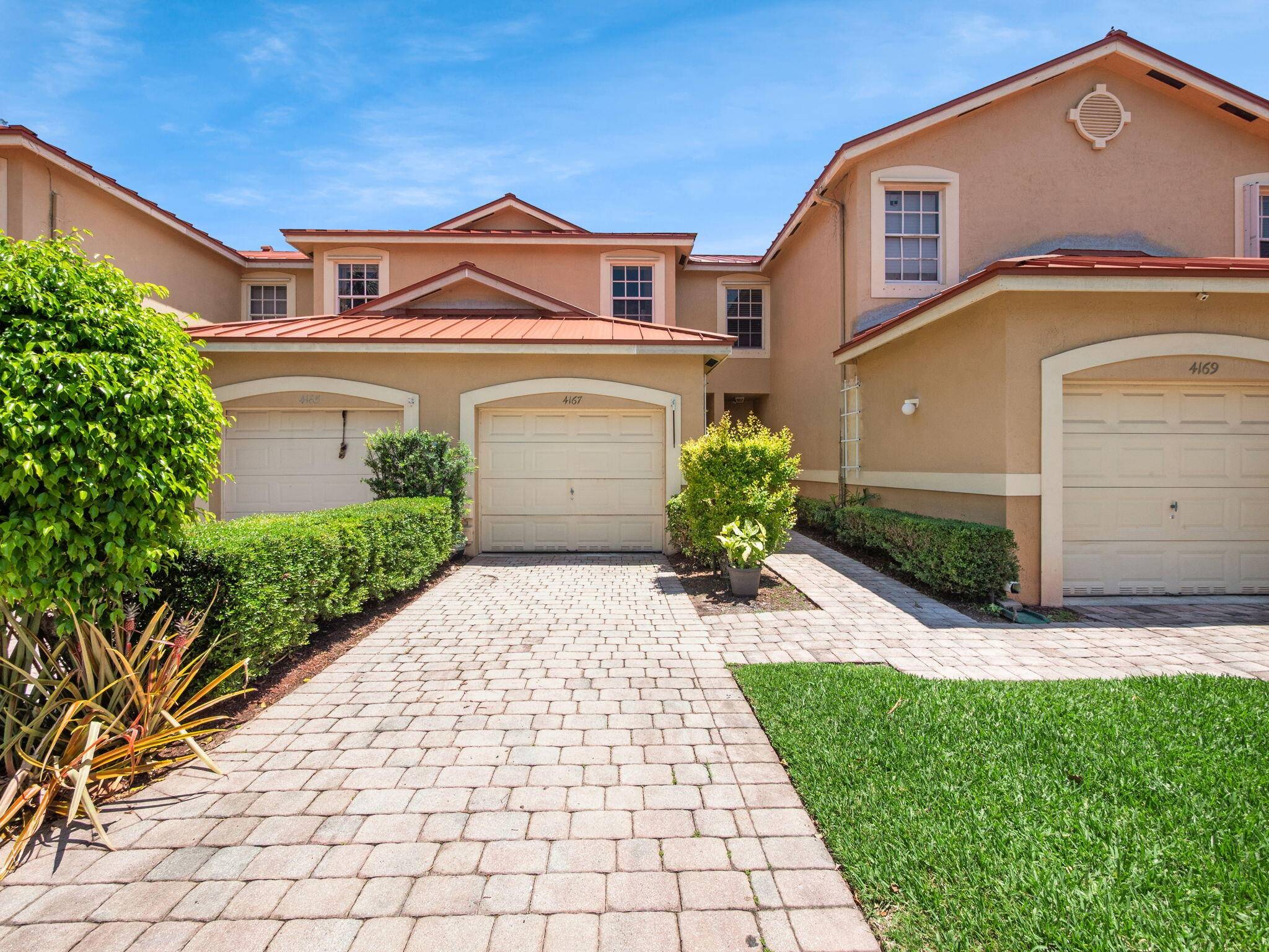 Great townhome offers 2 bedrooms, 2 full bathrooms, and a convenient half bath, featuring a spacious attached garage with ample storage space.
