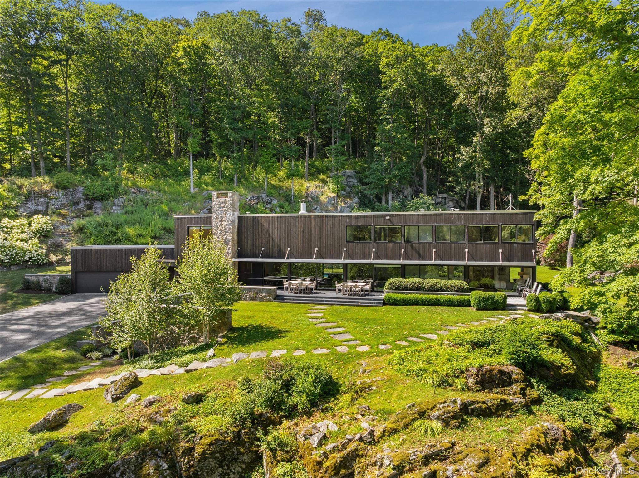 Experience modern design in perfect harmony with nature at 147 Mianus River Road.