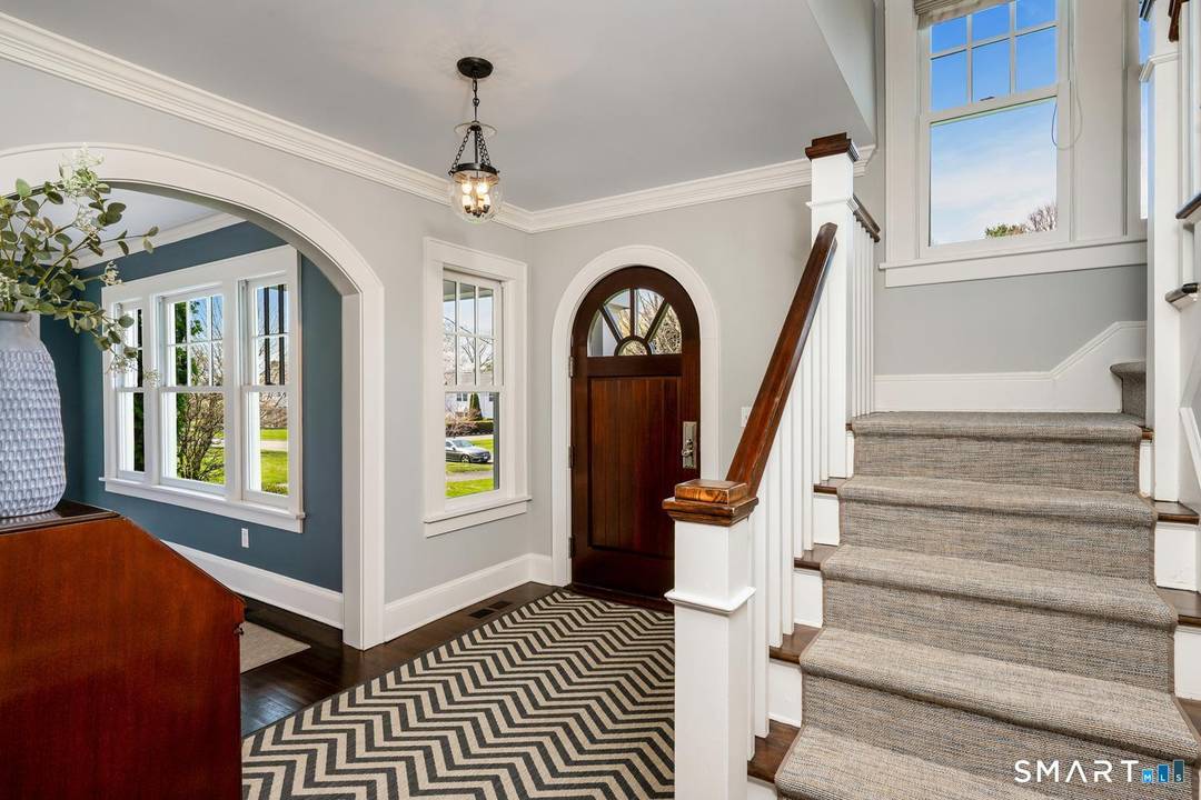 Masterfully renovated and expanded by renowned architect Chad Nehring, this 1929 Colonial features a chef's kitchen boasting a centerpiece 10' island, heated gunite pool, and seamless indoor outdoor living.