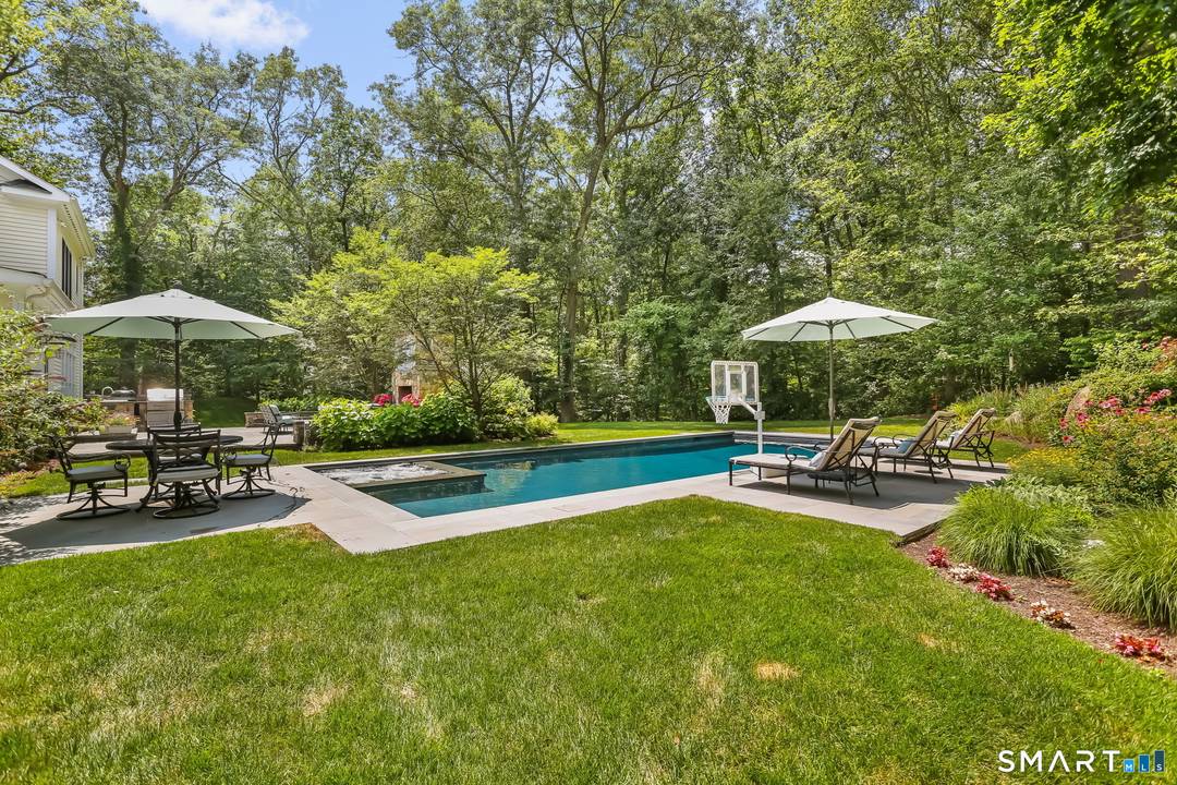 Classic 4 bedroom center hall Colonial set on a beautifully landscaped property with exceptional outdoor living.