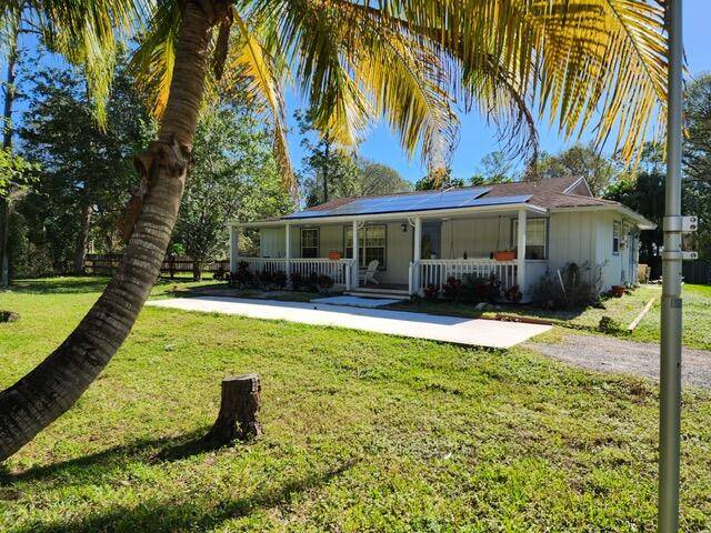 Welcome home to your very own cottage feel home situated on over 1 acre in the desirable area of Loxahatchee Groves !