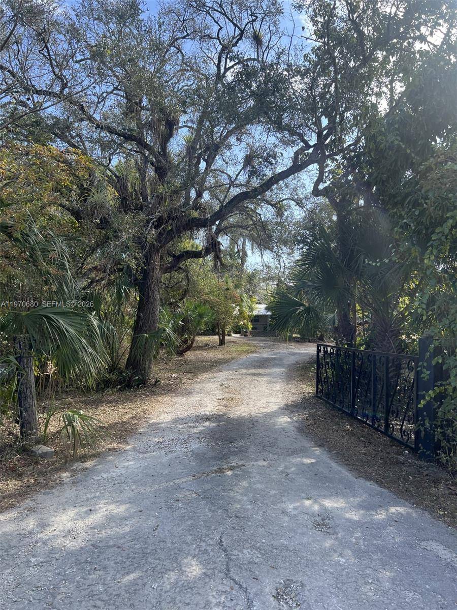 Stunning, unique, well maintained, fully fenced, Redland 5 acre Compound consisting of two homes, partially located in a gorgeous rare Hammock of trees and plenty of cleared land.