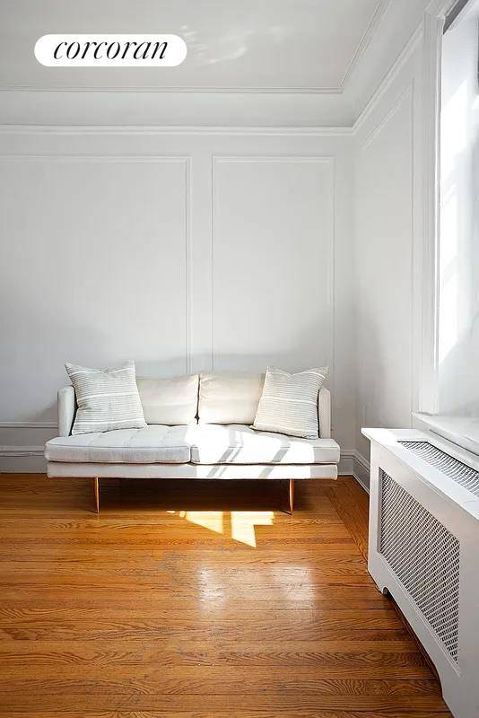 A bright studio with open city views from multiple exposures.