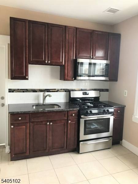 Beautiful renovated large two family, new roof, newer kitchen with 42 inch maple cabinets, granite countertop, stainless steel appliances, two units of furnace and AC condenser, hard wood floors, ceramic ...