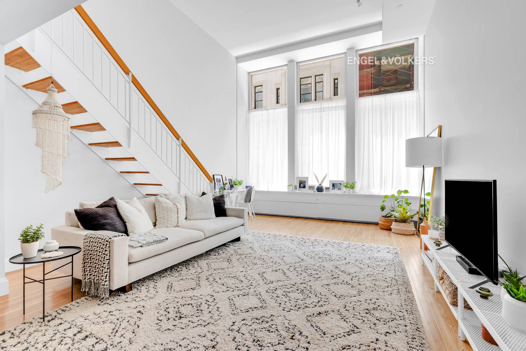 Luxuriously appointed, oversized duplex loft with 16 foot ceilings and a wall of 12 foot tall super quiet industrial tilt and turn windows.