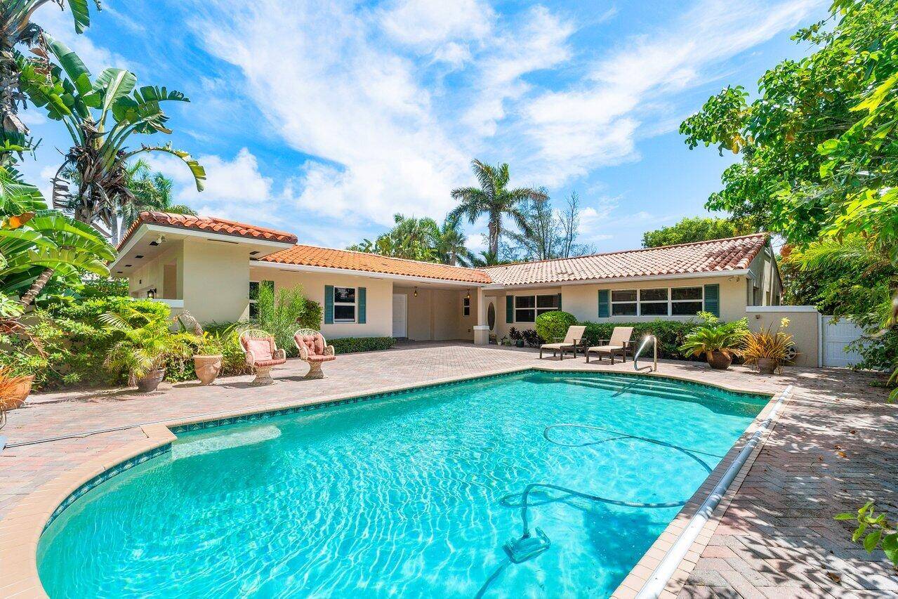 Live like you're on vacation in this classic mid century home on a 10, 500sf lot directly on the Lake Worth golf course w partial water views.