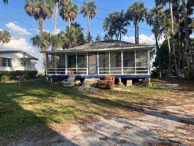 This 2 bedroom 1 bath home would be a great income producing property located on the main highway through town and is directly across from Lake Okeechobee.