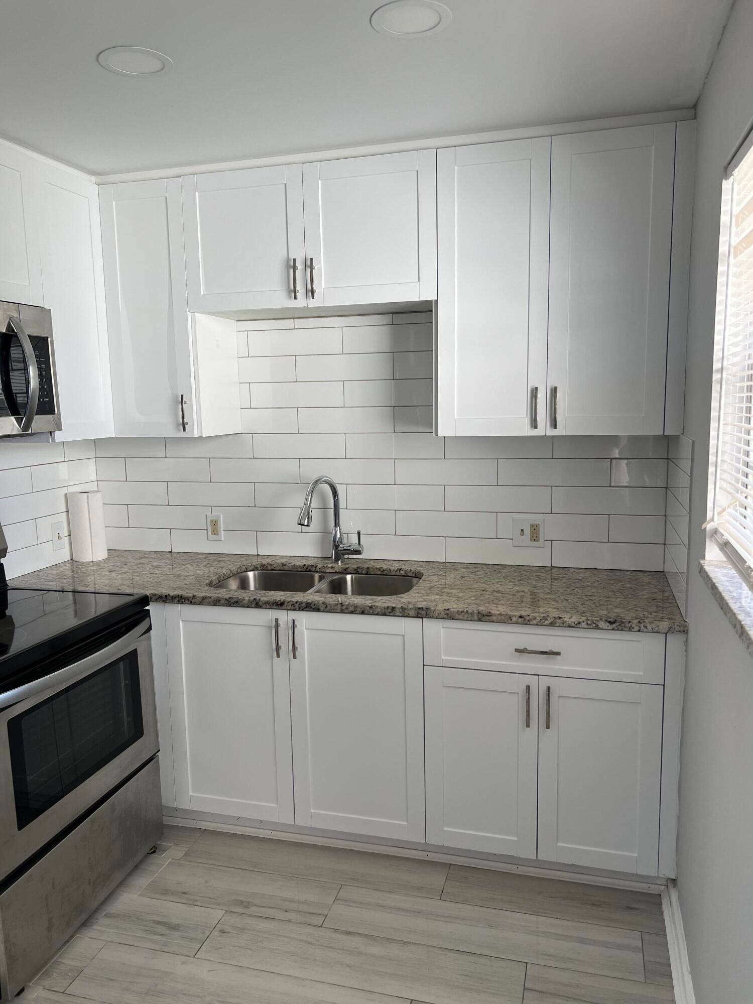 BEAUTIFUL, BEAUTIFUL, BEAUTIFUL TWO BEDROOM WITH A BATH AND HALFSTUNNING TILE FLOORS, STAINLESS STEEL APPLIANCES, NEW KITCHEN CABINETS, COUNTERTOPS AND BACKSPLASH.