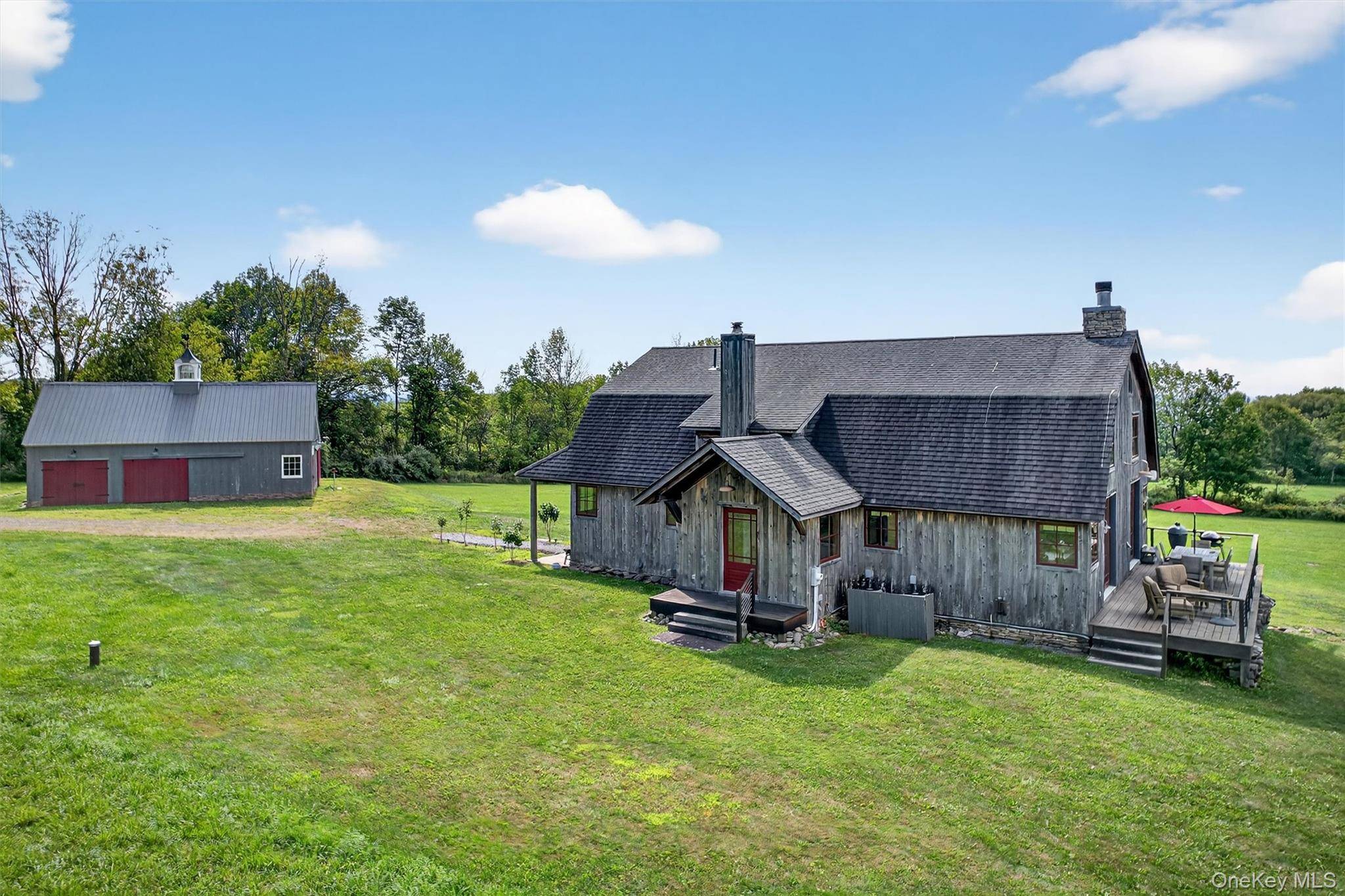 Step into serene sophistication with this immaculate custom contemporary Gambrel style country home, a true architectural showpiece blending rustic charm with modern design.