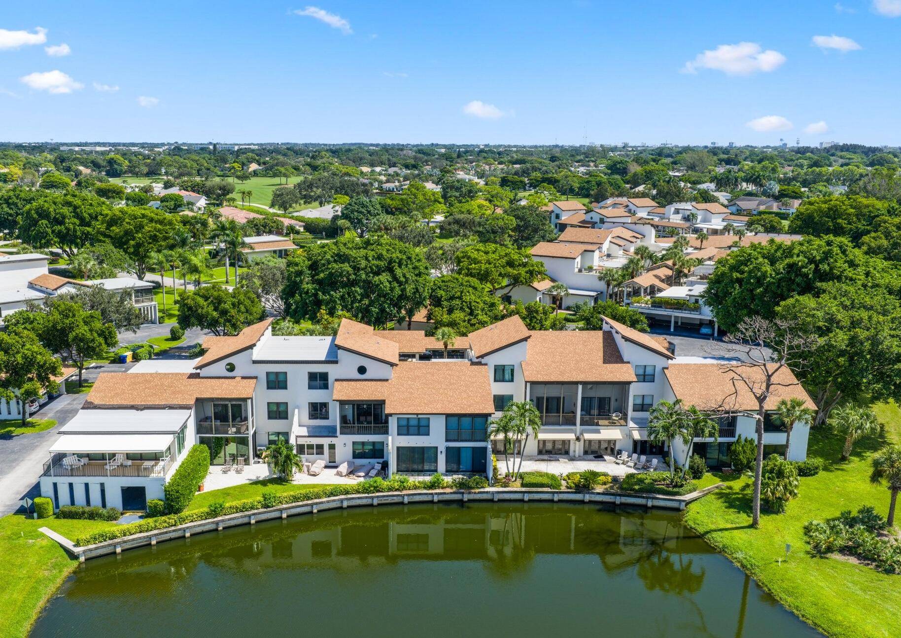 Welcome to the serene, lushly landscaped Seagate Country Club, where no membership is required to enjoy this spacious two story townhome style condo with fabulous golf course and lake views.