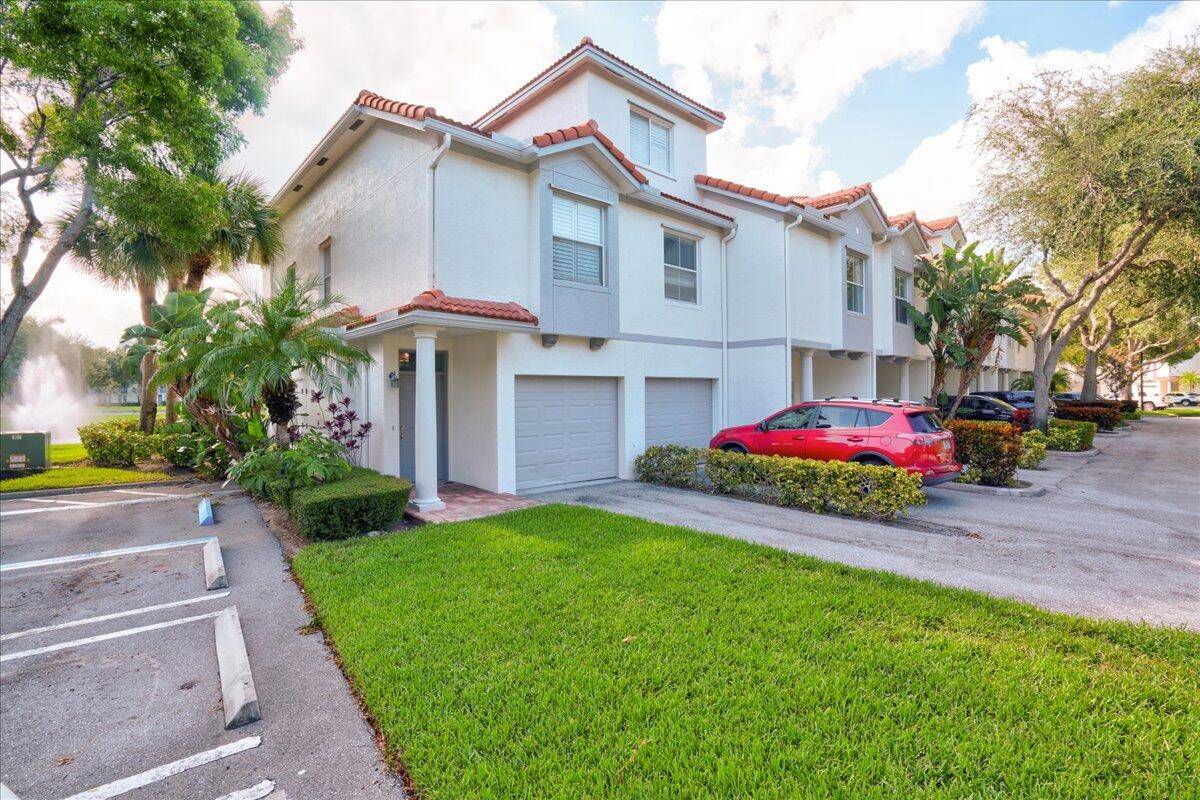 RARE LAKEFRONT CORNER UNIT Seldom available 3 story townhouse in an award winning gated East Delray just minutes from Atlantic Ave 4 stoplights to beach.