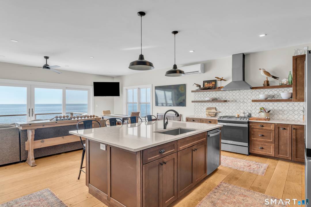 Panoramic vistas of Long Island Sound and the East River create a breathtaking backdrop for this sophisticated Madison waterfront retreat.