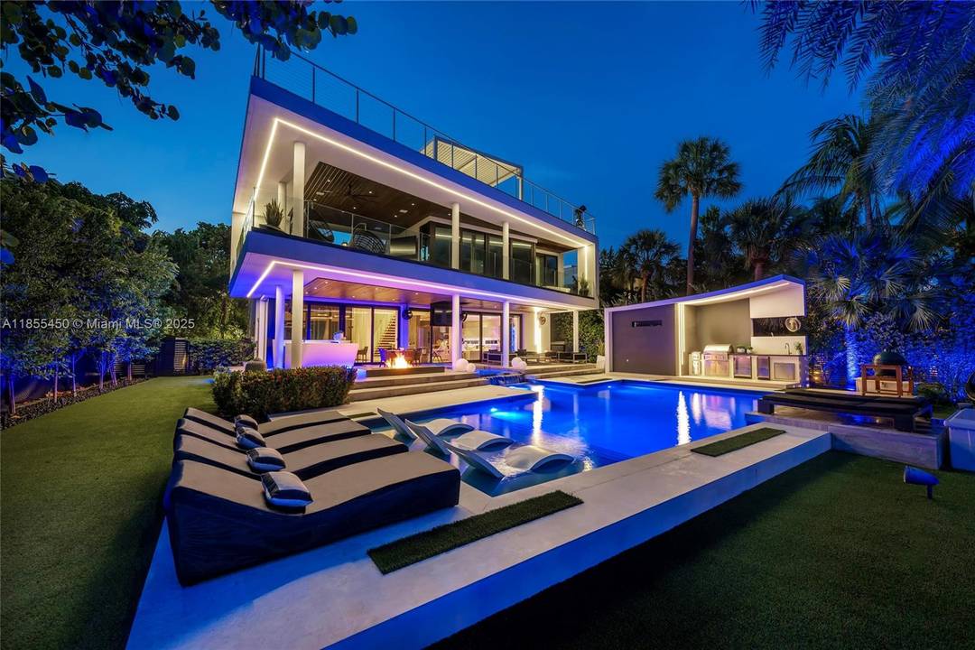 This striking modern tri level waterfront residence blends bold architecture with refined luxury.