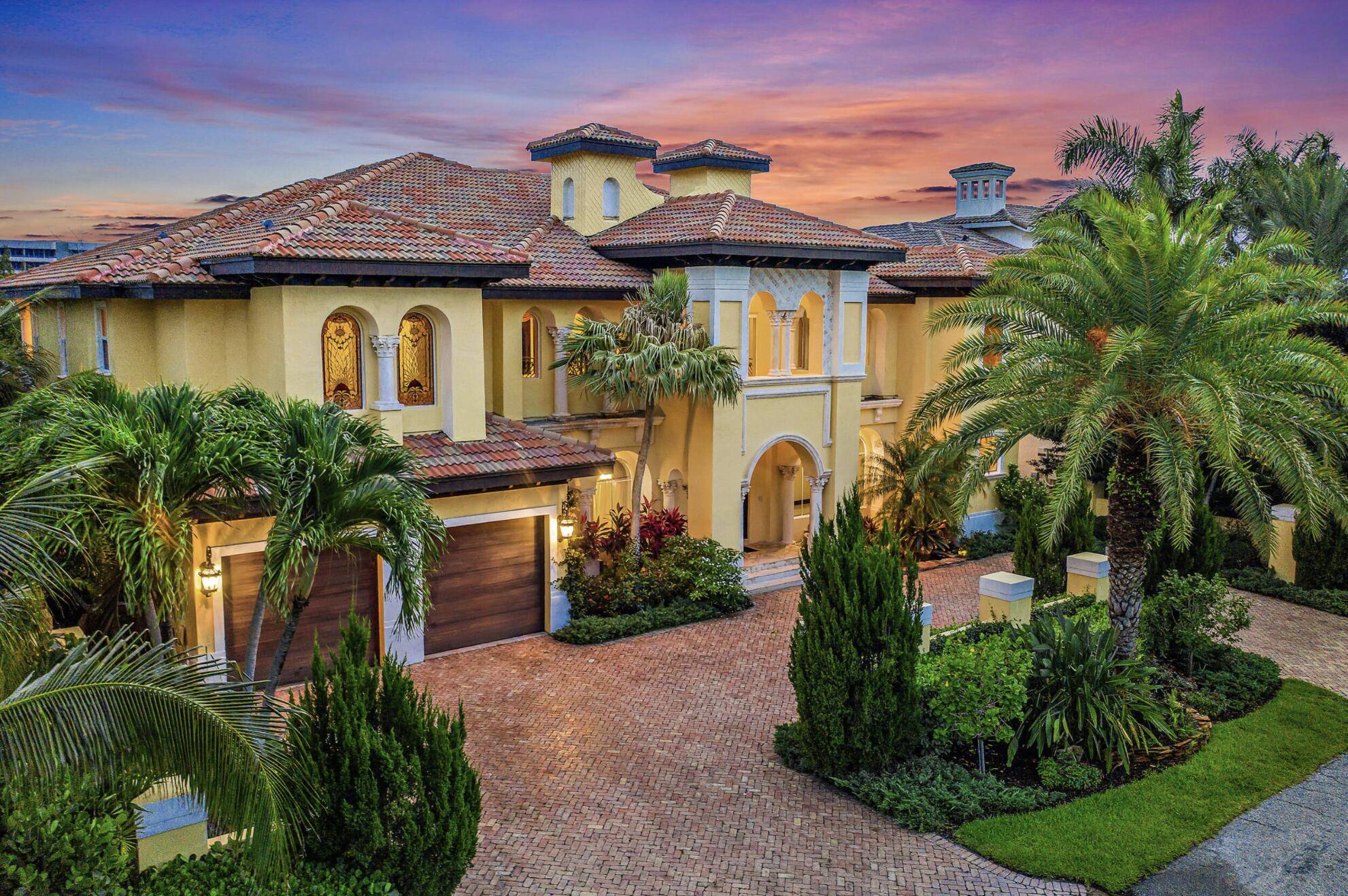 Stunning custom designed estate on deep water canal, 2 lots off intracoastal canal with lushly tropical landscaped setting and beautiful water views in desirable Tropic Isles.
