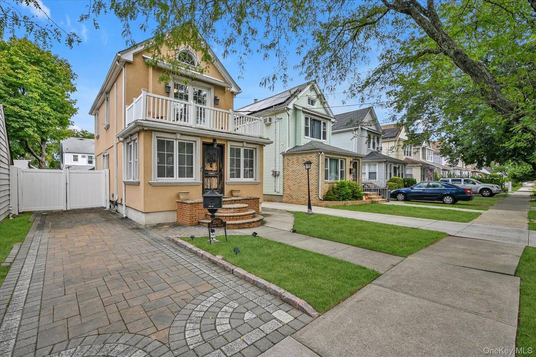 Welcome to this modern yet charming stucco Colonial located in the heart of Queens Village.