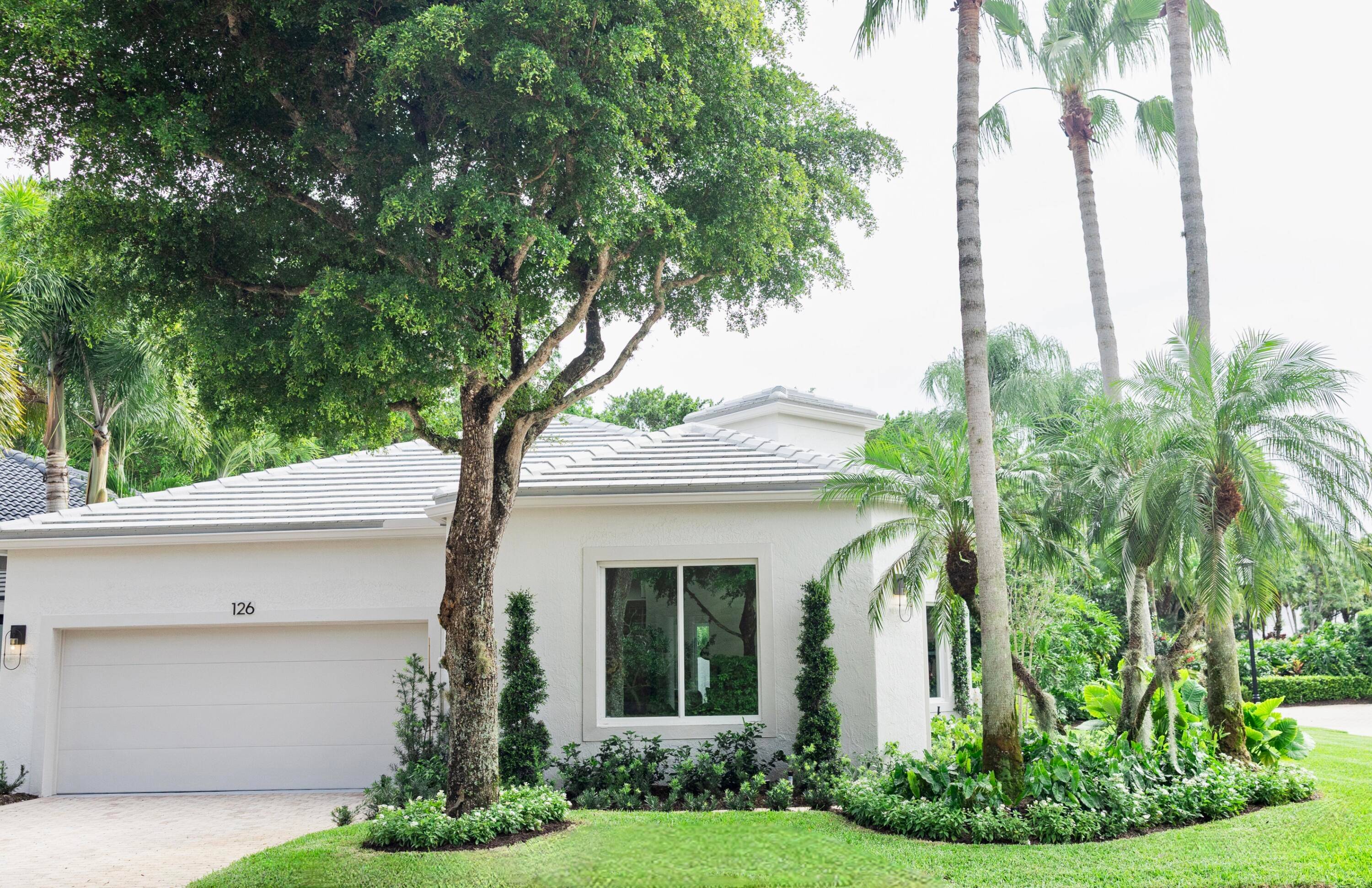 Step into refined living with this completely transformed home on a corner lot in the prestigious Ballenisles Country Club community.