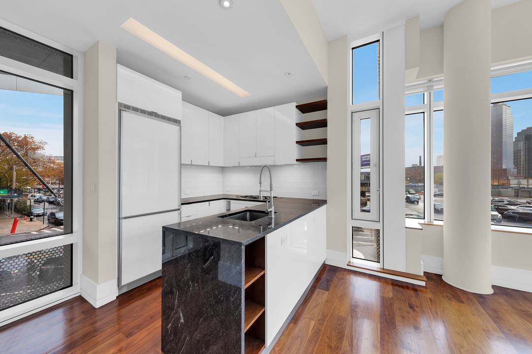 Bright Corner Loft with Soaring Ceilings and Triple Exposures Experience modern loft living at its finest in this sun drenched south corner residence at Hunters Point.