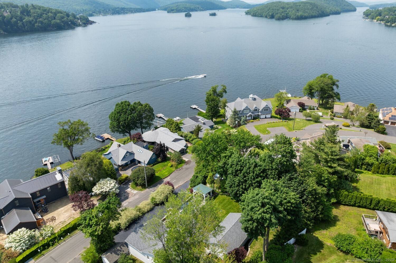 Welcome to 113 N Lake Shore Drive an exceptional, fully renovated ranch style retreat with sweeping views of Candlewood Lake.
