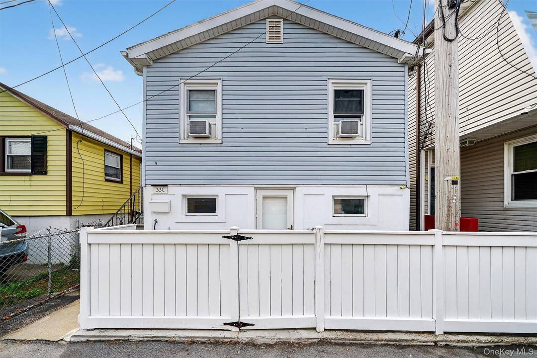 CO OP community large detached home offering three bedrooms, two full baths, updated, private community, hardwood floors, gas heat, less than a block from the water, low HOA.