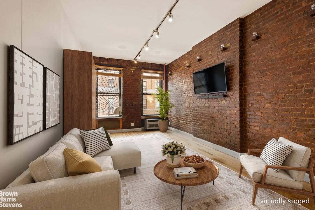 Charming East Village Condop Studio with Exposed Brick Bohemian chic studio on a coveted tree lined block in one of downtown's most desirable neighborhoods.