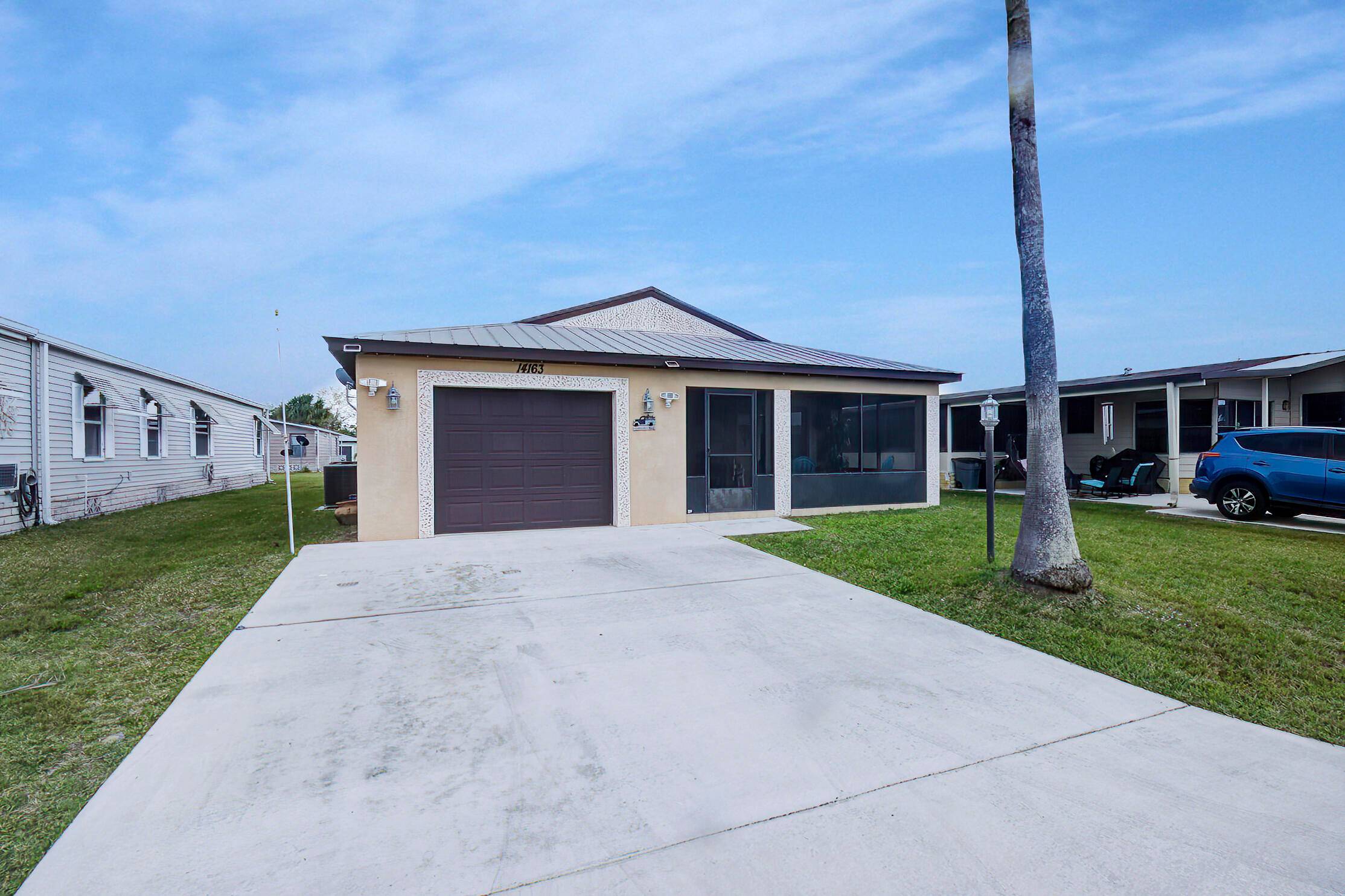 Elegant and beautifully upgraded 2 2 1 CBS home, featuring Quartz countertops, pristine white cabinetry, stylish tiled floors, and a large, screened porch.