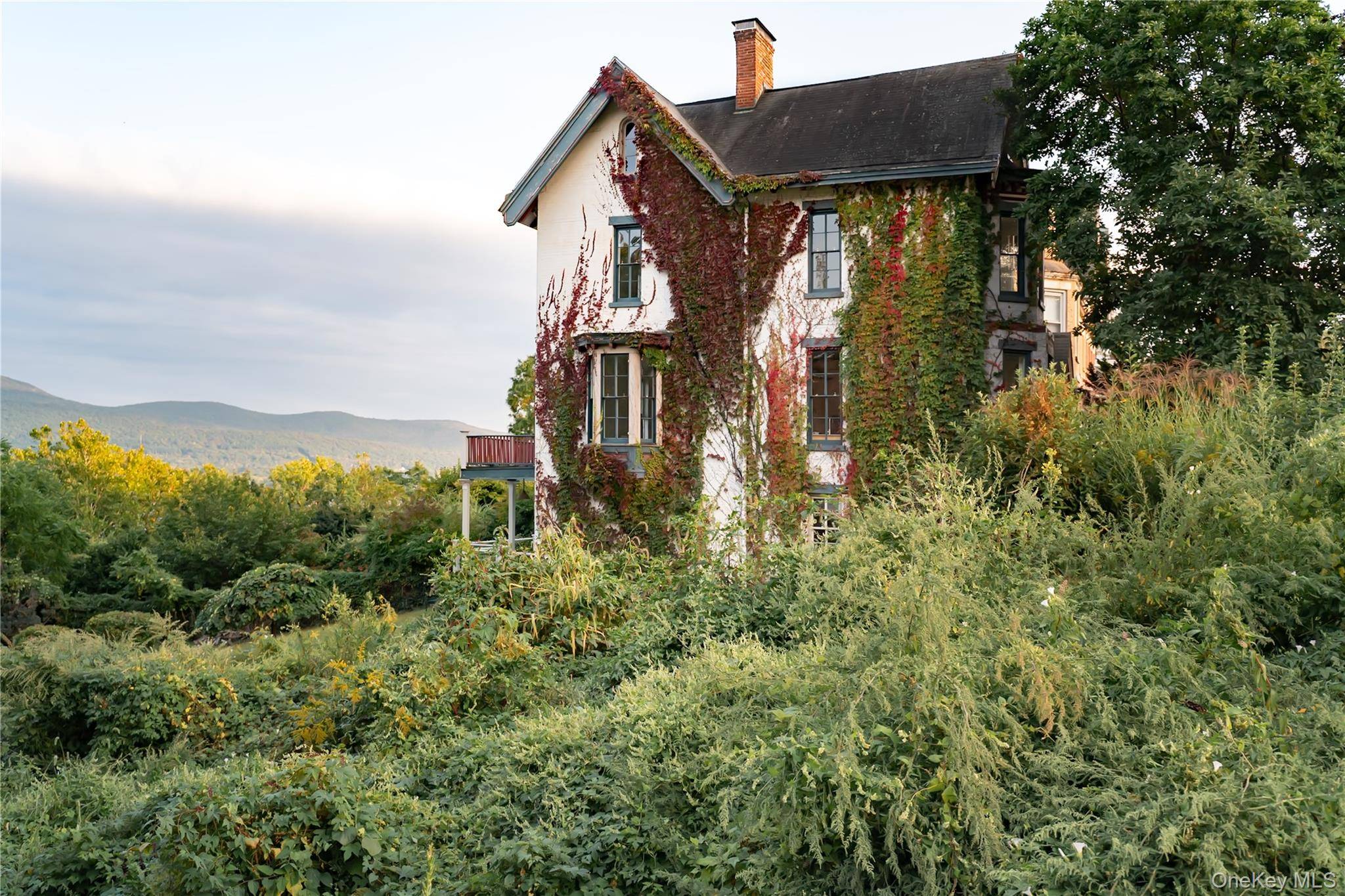 Set high on a hillside in New York State's largest historic district, this four story 1850s residence opens to uninterrupted views of the Hudson River and surrounding mountains.