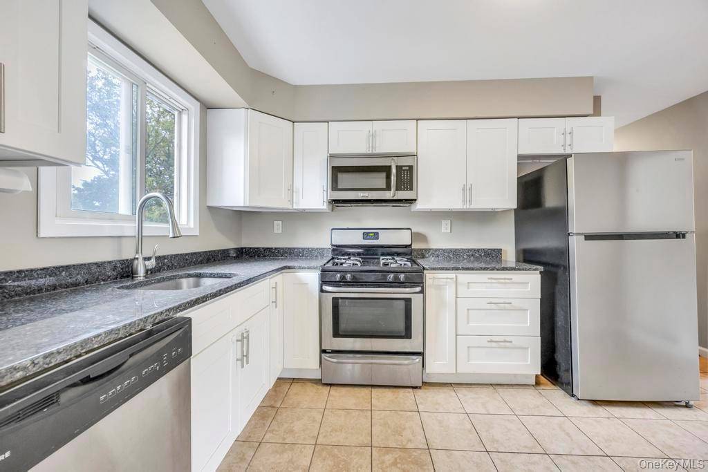 Welcome to this beautifully maintained 4 bedroom, 2 bathroom High Ranch nestled in the heart of West Babylon.