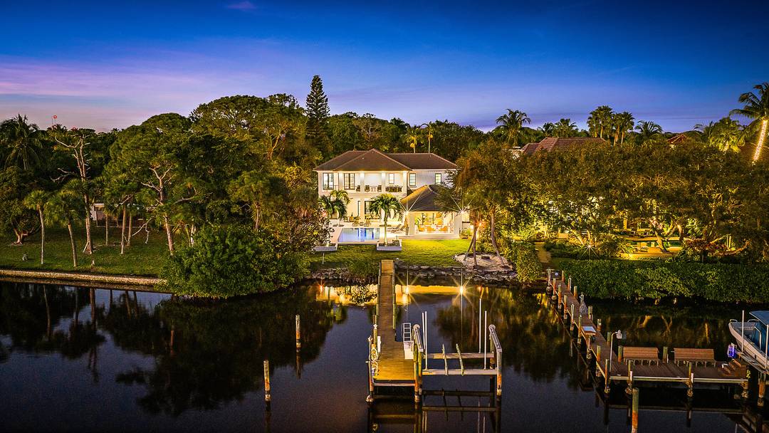 Nestled on nearly one acre of pristine riverfront, this exceptional estate offers breathtaking wide water views facing south.