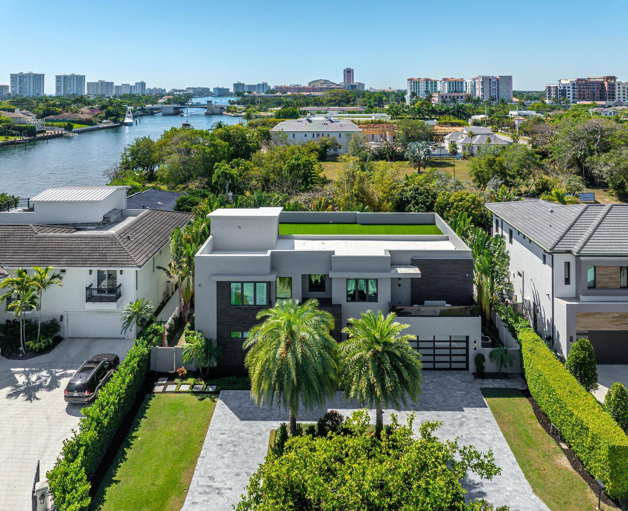 Tucked away on the smallest, most private cul de sac in Golden Triangle, a dramatic three story contemporary ultra custom residence is right beside Boca Raton's downtown intracoastal waterway.