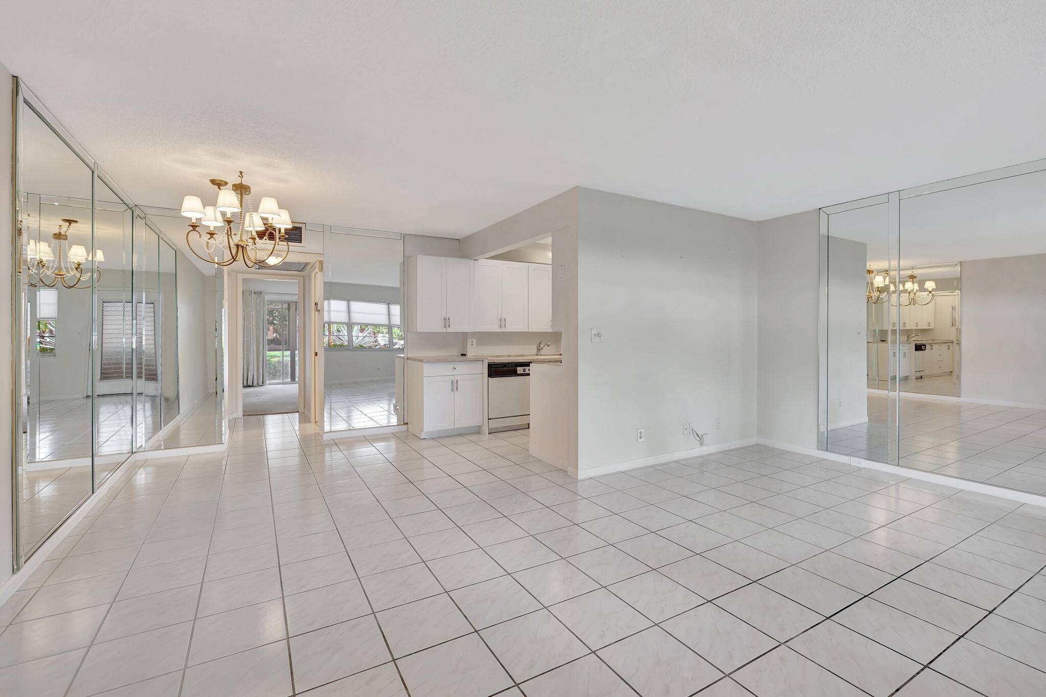 Step into your new ground floor unit featuring a serene water view, brand new AC, and beautifully updated bathrooms and kitchen, all within a cozy 798 sq.