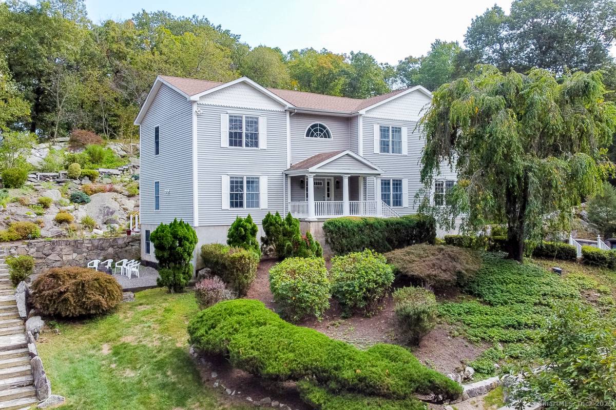 Welcome to this stately center hall colonial with a gracious 2 story entry hall nestled on a private 2 acre lot.