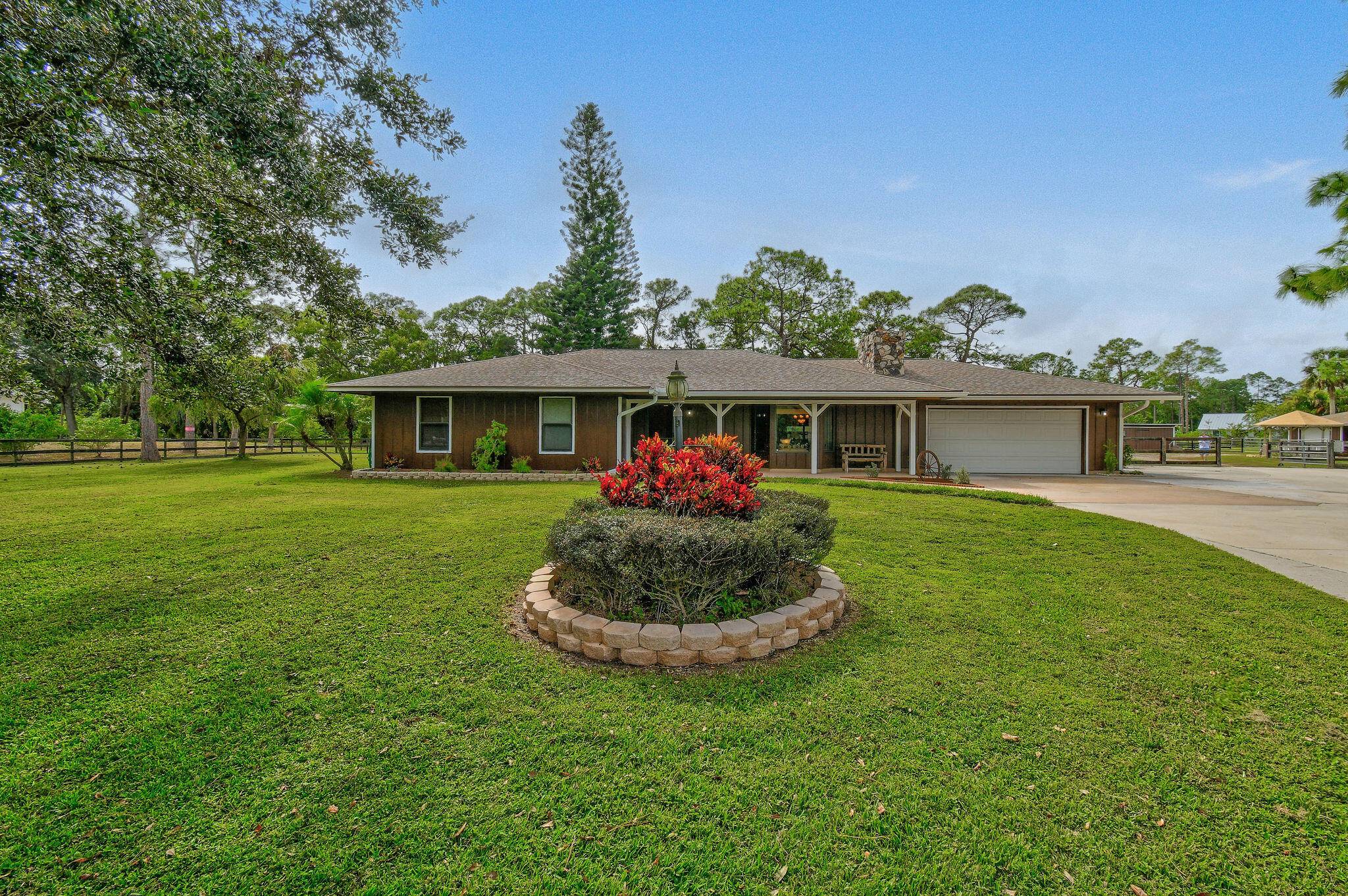 Welcome to Jupiter Farms, this home is located on over 2 acres of beautifully maintained land.